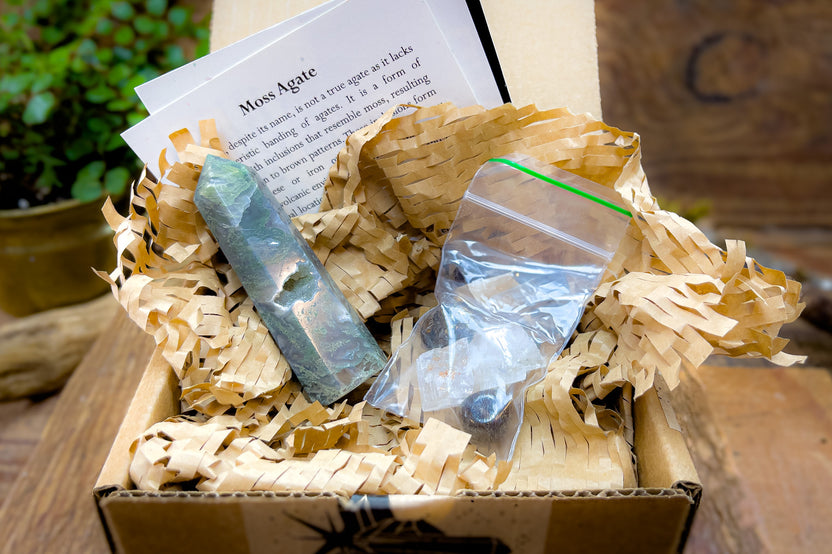 Open box example of Enchanted Crystal subscription box, with single featured crystal and all recycled or recyclable packaging 