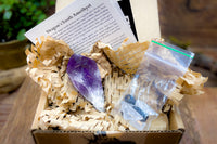 Open box example of Enchanted Crystal subscription box, with single featured crystal and all recycled or recyclable packaging 