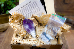 Open box example of Enchanted Crystal subscription box, with single featured crystal and all recycled or recyclable packaging 
