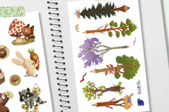 An open notebook featuring two sticker sheets - one with pencil shaped trees and another with woodland animals using stickers.