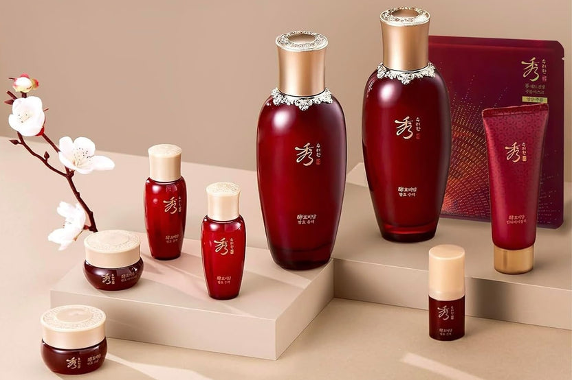 Asian skin care products and spa products layed out on a brown table with a japanesse nature on the left.
