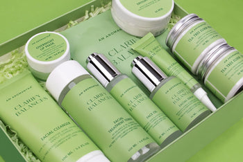 Skin care, spa and health gift box full of different spa products with the color green, laying on a green table.