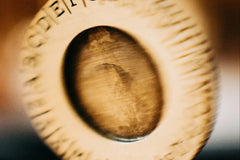 Close up blurred photo of a spinning coin that is a part of an escape mystery game. The coin is made from wood.