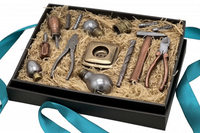 A black gift box filled with handmade chocolate tools, including pliers, a hammer, screwdrivers, drills, light bulbs, and a socket