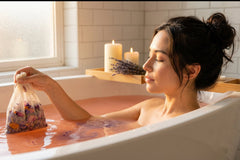 Woman relaxing in bath using ILUVNIKI herbal bath sachet for anxiety relief and nervous system support