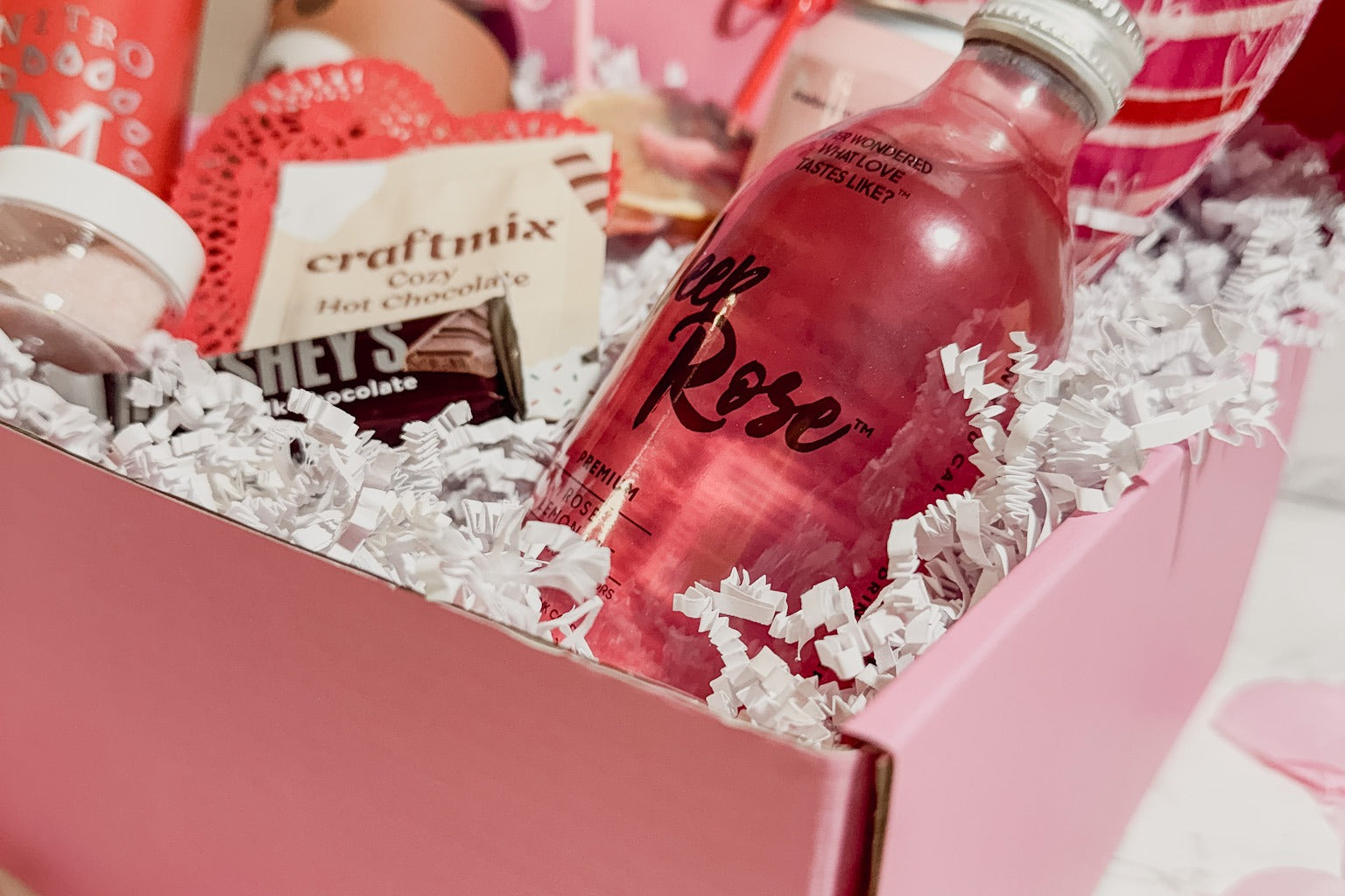 Discover a stylish pink mocktail box filled with refreshing non-alcoholic drinks, perfect for any occasion.