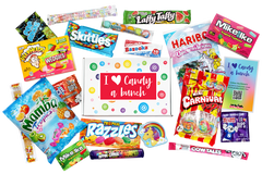 Colorful full print box with I heart sticker on top surrounded by all the sweet candy treats that would be included in the gift.  
