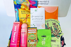 Colorful TEEN WISHBOX subscription box filled with skincare, socks, and snacks, ideal as a holiday gift for teens