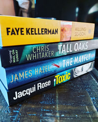 Crime thriller books, stacked on top of each other with intriguing covers, perfect for mystery lovers