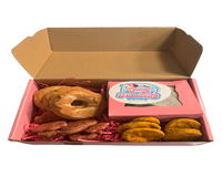 Assorted handmade organic bakery-style dog treats including decorated cookies and donuts