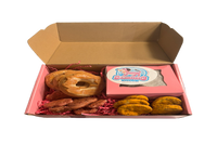 Assorted handmade organic bakery-style dog treats including decorated cookies and donuts
