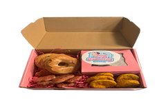 Assorted handmade organic bakery-style dog treats including decorated cookies and donuts