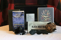 This is a picture of the book titled Disappearance at Devil's Rock, the book wrapped in paper, newsletter, Hellraiser puzzle, and other gift