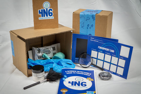 The activity box and its contents are displayed. Some of the contents include a fingerprint brush, fingerprint powder, and fingerprint cards