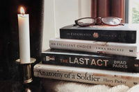 Brown subscription box filled with four historical fiction books, featuring rich narratives and captivating tales set in different eras.