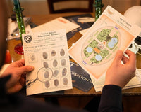 A person holding 2 papers with text and photos that are part of a mystery detective escape game with a skeleton next to it.