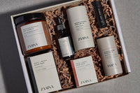 Gift box from Zaaira brand of mens self care and skin care products in a beautiful box. Laying on a table.