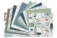 Colorful scrapbook papers and stickers in a monthly scrapbook kit featuring floral designs and cameras, ideal gifts for women