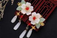 Chinese inspired ancient stone flower earrings wit red and gold accents. These earrings are dangling type 2 inch long pierced earrings .