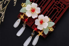 Chinese inspired ancient stone flower earrings wit red and gold accents. These earrings are dangling type 2 inch long pierced earrings .