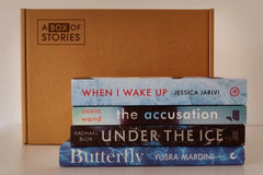 Brown subscription box filled with four fantasy novels, featuring magical worlds and adventurous plots for fans of imaginative storytelling