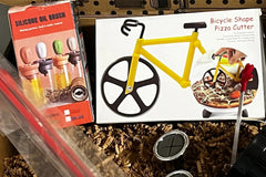 A subscription box full of different kitchen gadgets that are used for cooking, meal prep, or clean up.