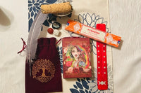 oracle deck, smudge stick with shell on stand, feather, incense, incense holder, Oracle pouch, crystals