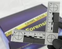 A blue box containing a forensikit is displayed in the back while a white evidence scale is in the foreground