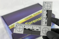 A blue box containing a forensikit is displayed in the back while a white evidence scale is in the foreground