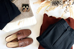 a beautiful collection of fall thrifted pieces including leather loafers, a cream cardigan, mock neck shirt and pleated pants