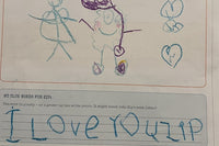A child's reply to Zip drawn in crayon, with two stick figures, hearts and the words I love you Zip written in big blue letters.