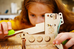 A child getting ready to launch a ball from BrainStorm's Catapult STEM Kit.