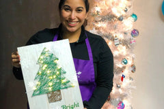 Woman showing off her Christmas light up nail string art project | Panache Craft Box - Monthly Craft Box + Live Virtual Art Class 