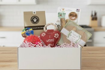 Box includes;
One full size bag dog treats,
One Chew Toy
One Plush/Rope/Ball
One themed gift for the human 
