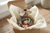 Handcrafted vintage-style wooden ornaments featuring art paper designs, finished with rustic details
