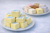 Assorted gourmet marshmallow squares in seasonal flavors on a white plate for marshmallow of the month club.