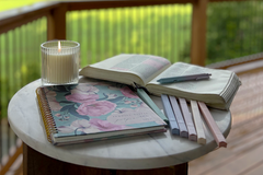 Promise Keeper Christian Journal Planner Subscription On Outdoor Porch with Candle and Bible plus Highlighters 