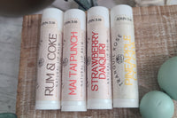 Wellness gift set with natural skincare products in a decorative subscription box. Includes natural lip balm happy hour themed set