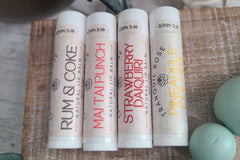 Wellness gift set with natural skincare products in a decorative subscription box. Includes natural lip balm happy hour themed set