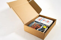 Brown box filled with fiction books, showcasing a variety of gripping titles and intriguing covers, perfect for mystery lovers.
