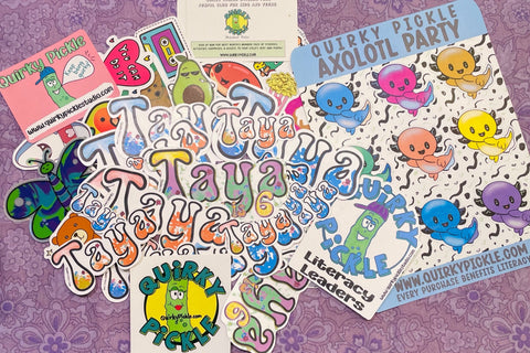 Personalized die cut stickers for subscriber Taya are shown, as well as a sheet of colorful axolotl stickers and other die-cuts from a pack.