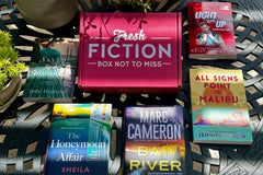 book on table surrounded by books