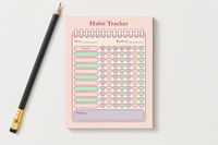 Habit Tracker notepad in soft pink with heart check-offs for each day of the week and a notes section at the bottom