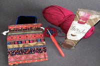 Phone pouch which you will receive with the first box to put your phone inside.  Hot chocolate on a spoon and ball of yarn.