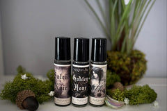 Muse Fragrances by SugarMuses® nestled in a small black box packed with organic moss and other botanicals.