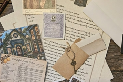 Literary gift for mystery lovers with monthly cozy mystery letters, puzzles, tea, postcards, and immersive reading experience.