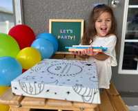 Excited child with Owl Post Books kids subscription box and books, a fun holiday gift idea and book club present for young readers.