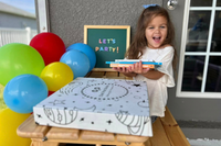 Excited child with Owl Post Books kids subscription box and books, a fun holiday gift idea and book club present for young readers.