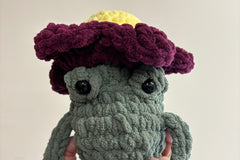 The small frog with a flower hat.   the small size mystery toy box includes a handmade crochet toy approximately 8-11" 
