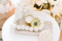 Celebrated the holiday season with a cream wool ball garland, woodsy candle + a hand-embroidered ornament.